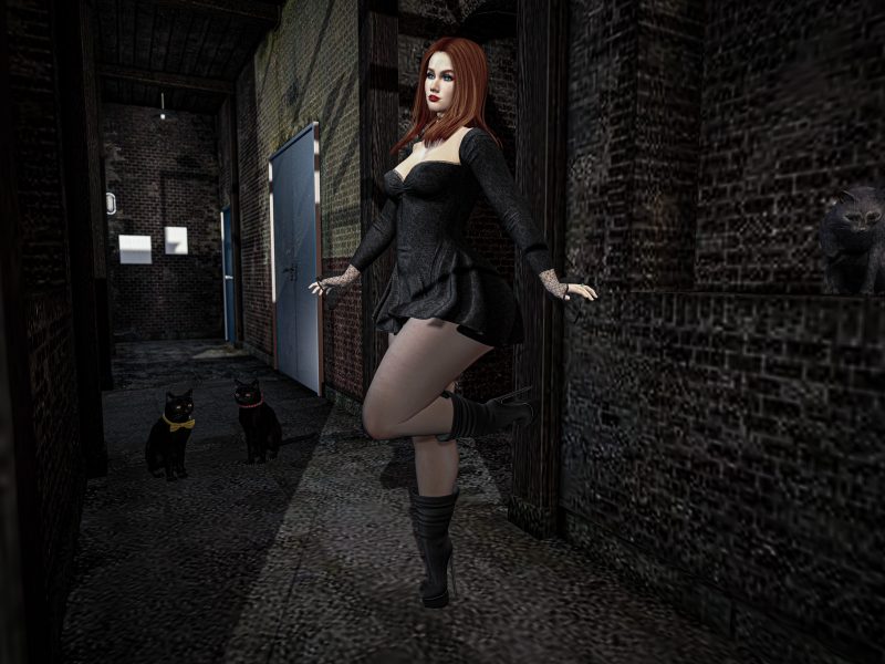 Stylish woman posing in black dress, leaning playfully in a Second Life alley